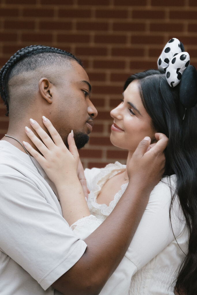 cute couple looking and smiling at each other at their romantic engagement session