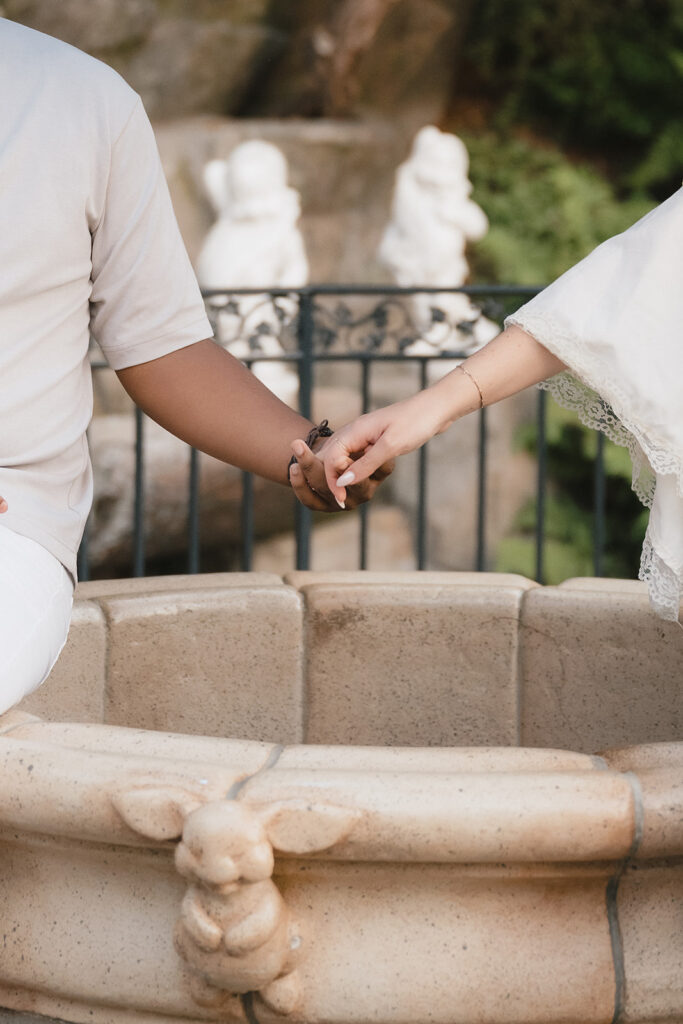 newly engaged couple holding hands