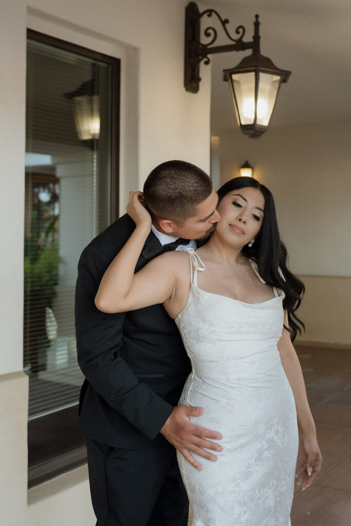 groom kissing the bride on the cheek