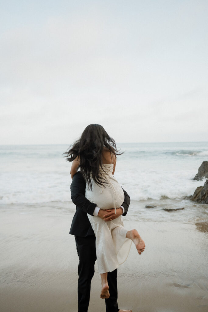 couple playing during their beach photoshoot