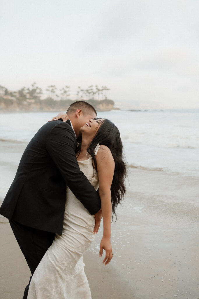 groom kissing the bride on the cheek