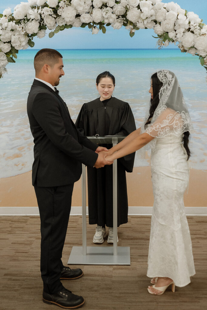 couple holding hands during their wedding ceremony