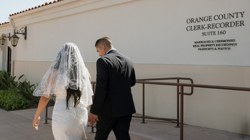 couple heading to their elopement ceremony at laguna hills civic center