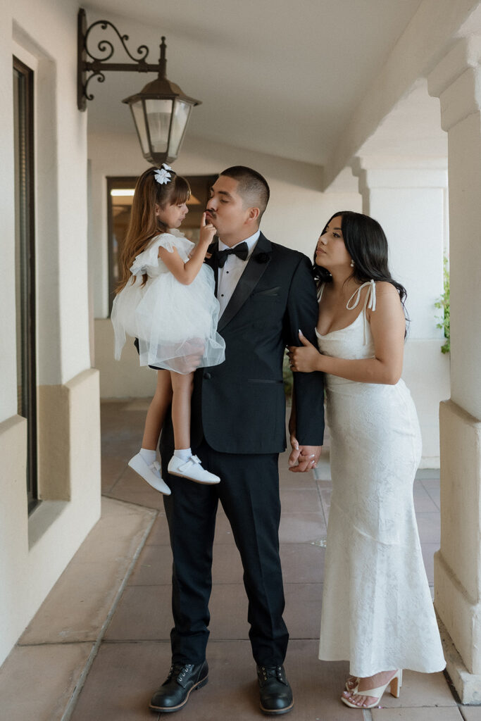 picture of the bride and groom with their daughter