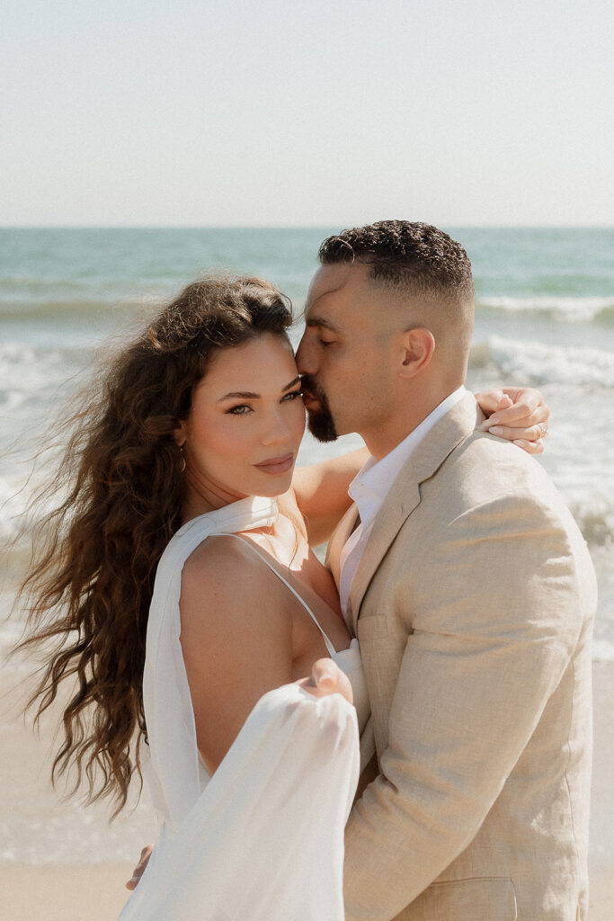 cute couple looking at the camera during their photoshoot 