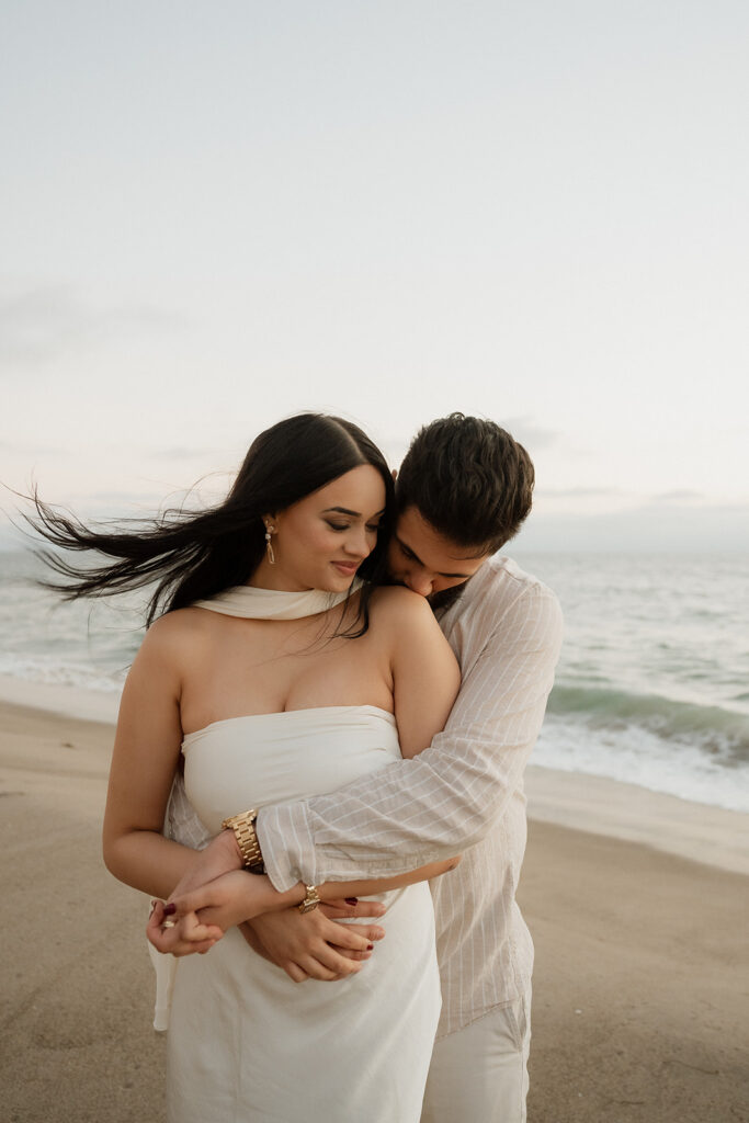 couple hugging during their romantic beach engagement session