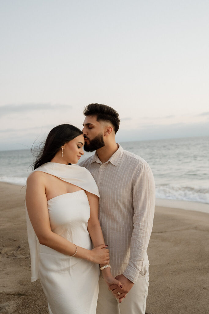 fiance kissing his fiance on the forehead 