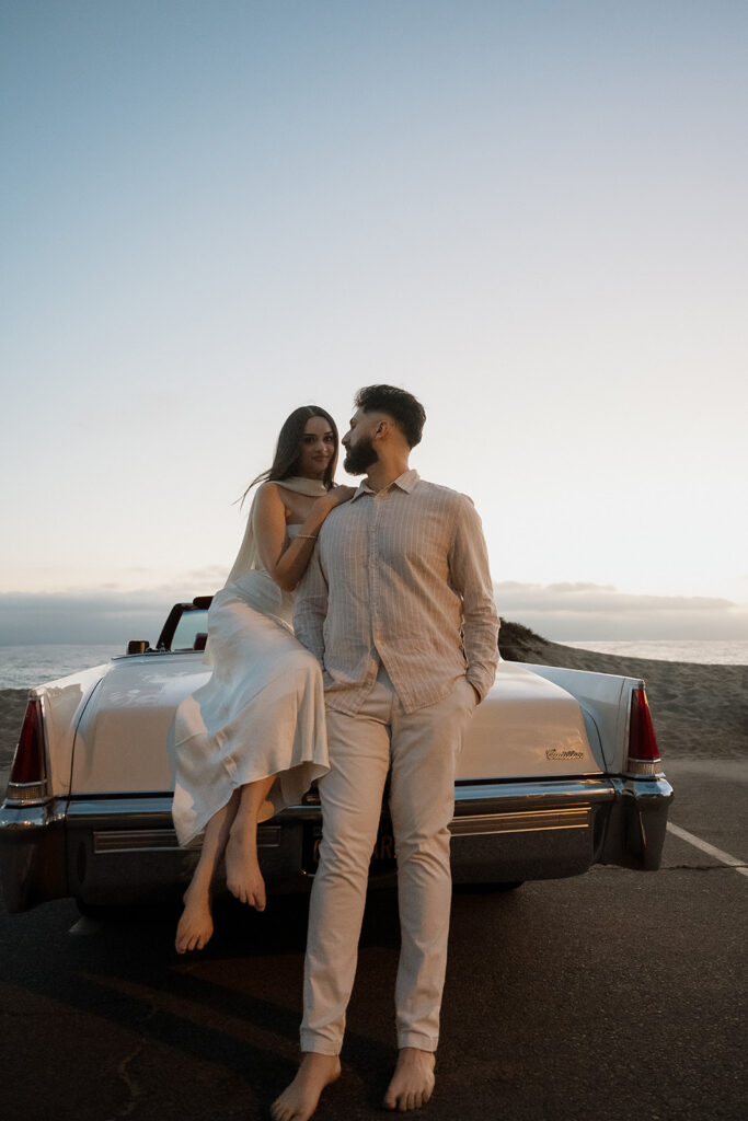 newly engaged couple looking at each other during their beach engagement session