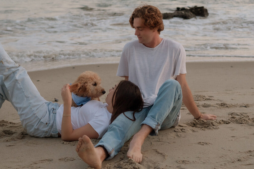 couple sitting looking at the beach 