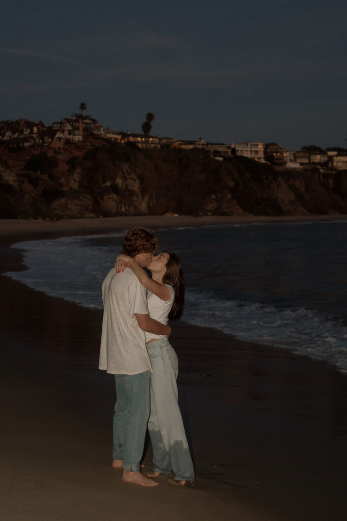 picture of the cute couple kissing at the beach 