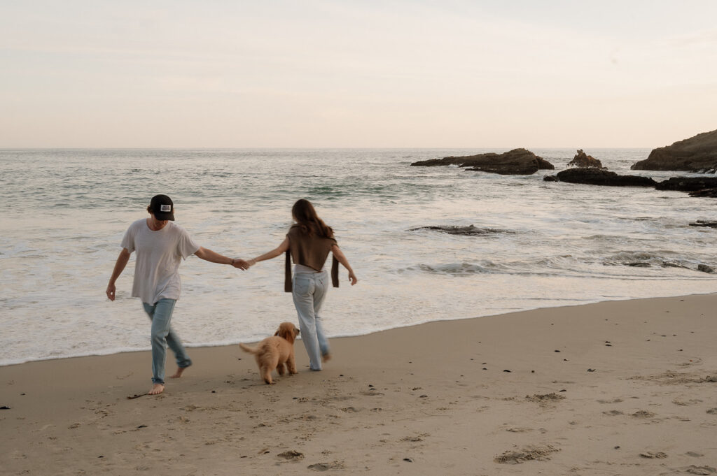 couple walking around laguna beach during their photoshoot