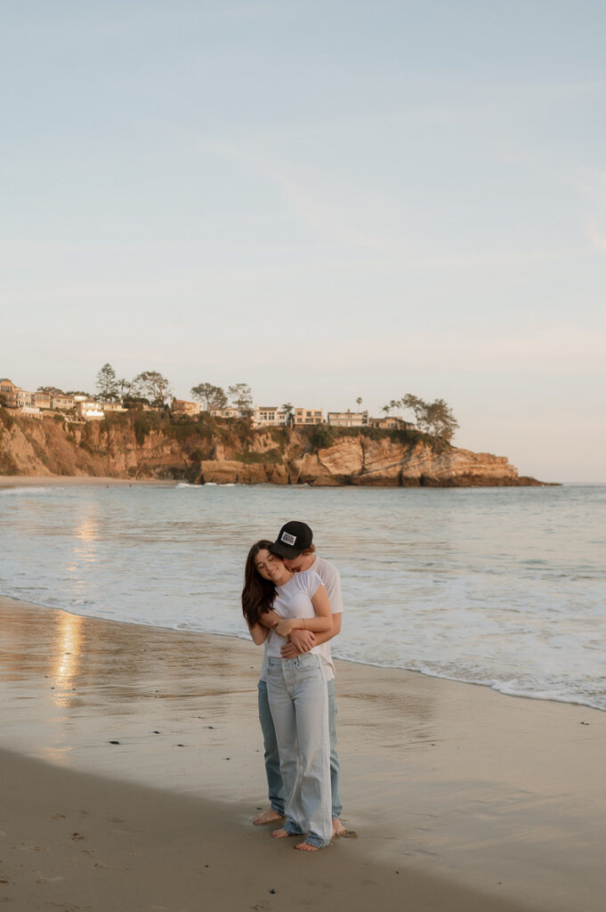 cute picture of the couple hugging during their beach couples session in laguna beach 