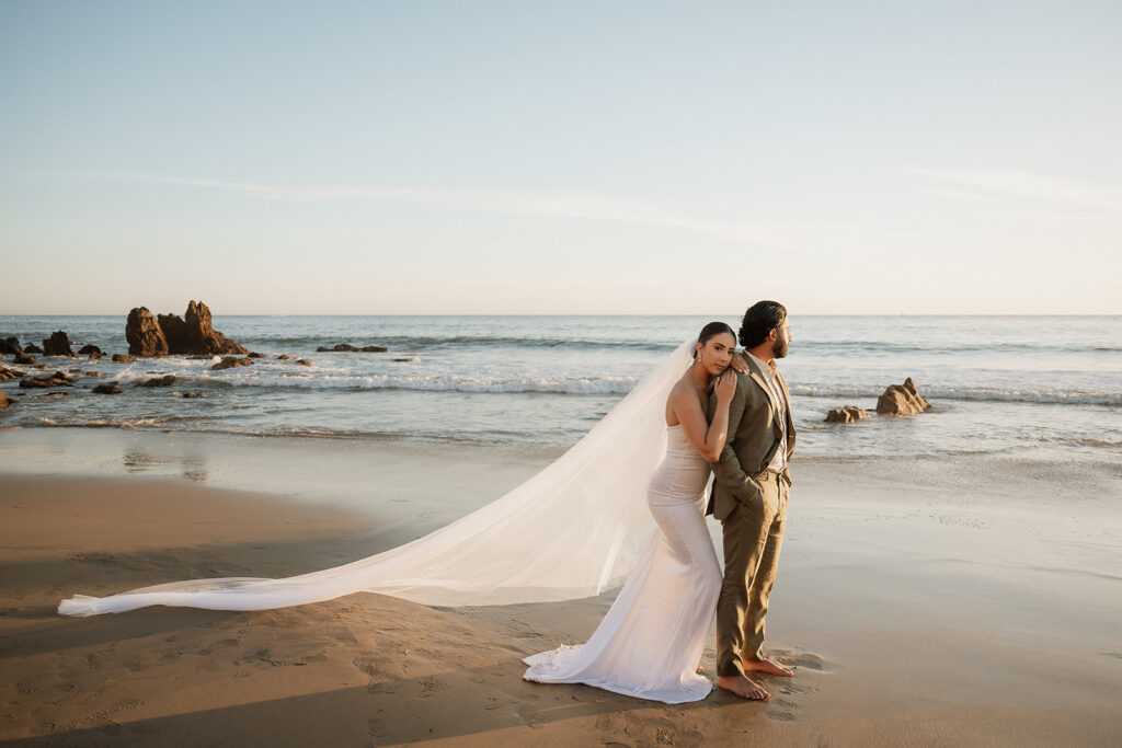 cute picture of the bride hugging the groom 