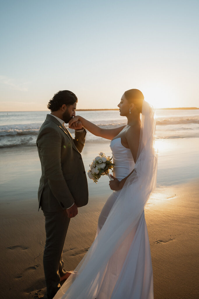 groom kissing the bride on the hand