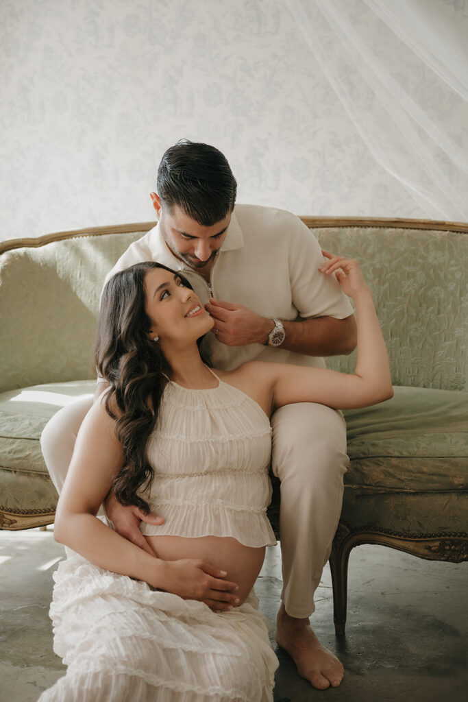 cute soon to be parents smiling at each other