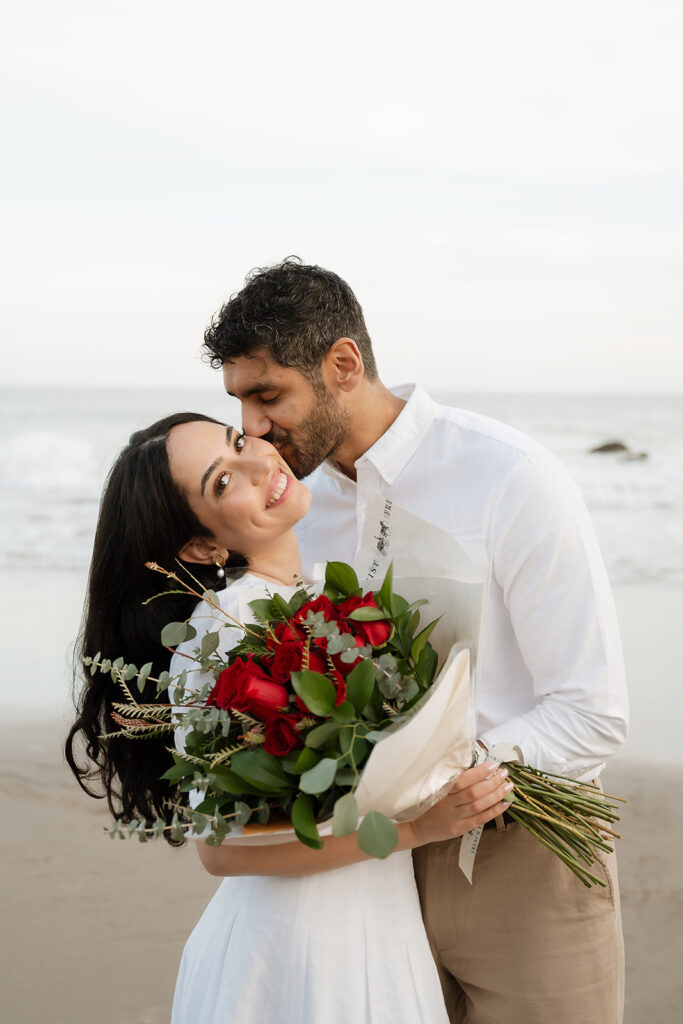 fiance kissing his fiance on the cheek