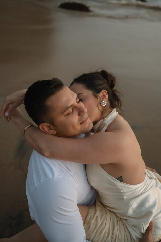 couple playing at the beach during their dream engagement session