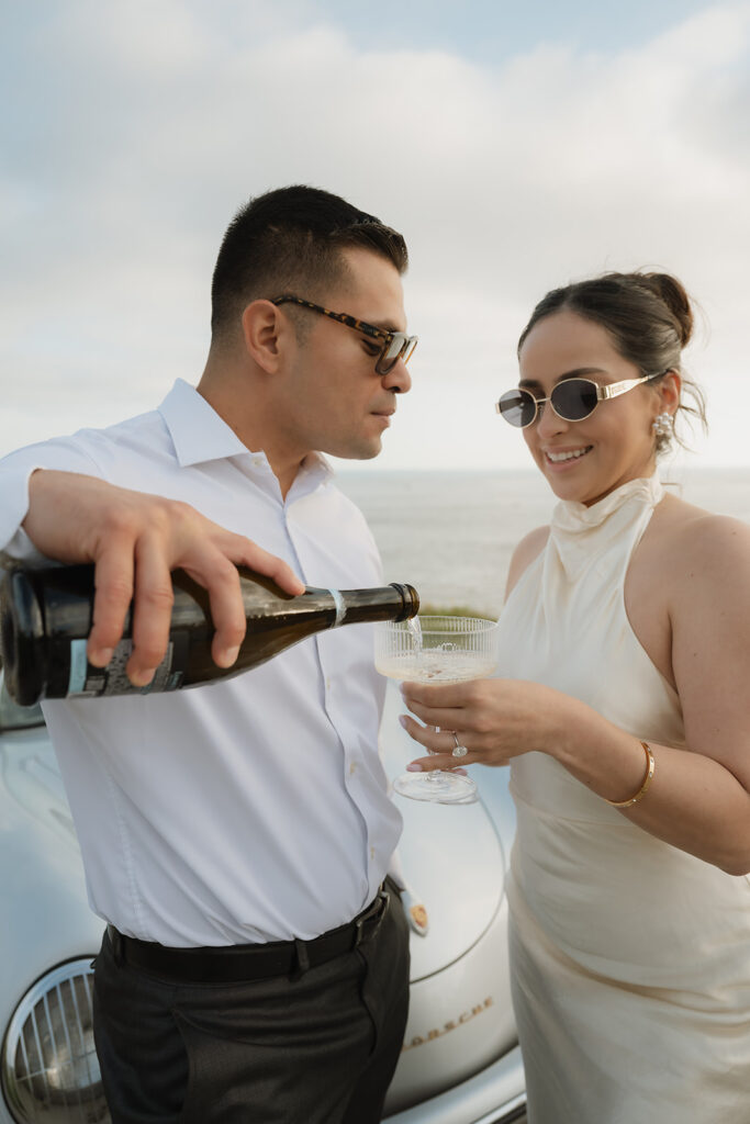 cute picture of the couple celebrating their engagement with champagne