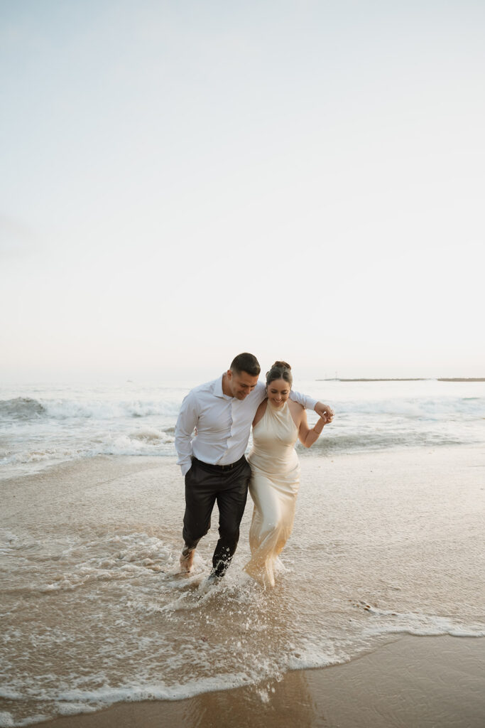 cute couple hugging and walking around the beach 