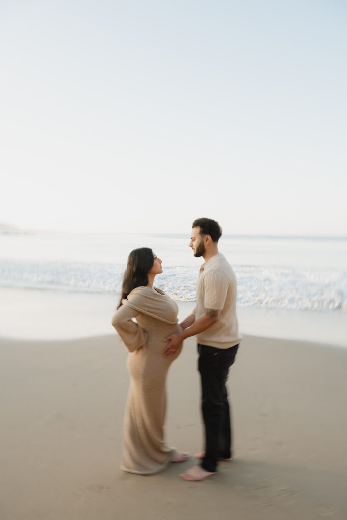 couple smiling at each other during their session