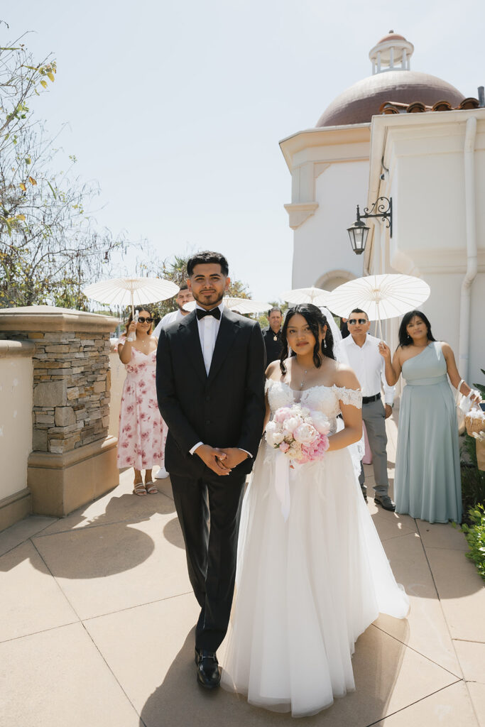 bride and groom and their family heading to the ceremony location