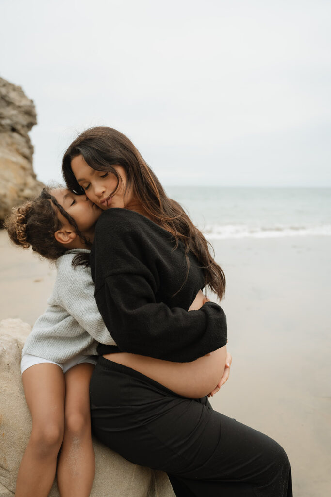 daughter kissing her mom on the cheek