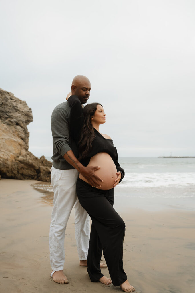 couple at their beach maternity photos