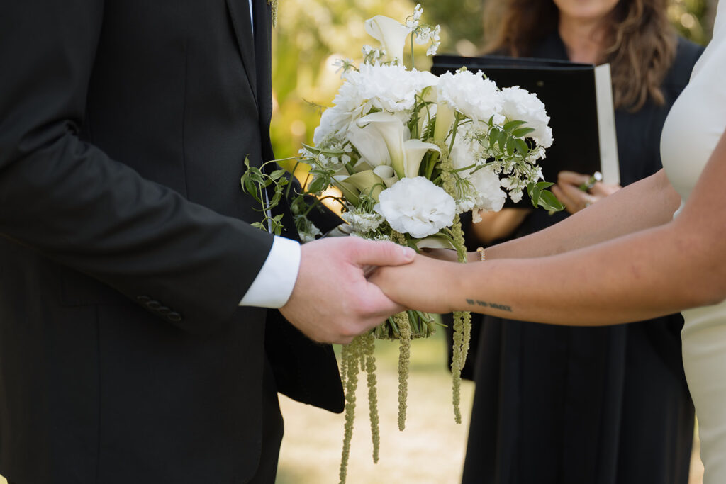 bride and groom holding hands during their ceremony