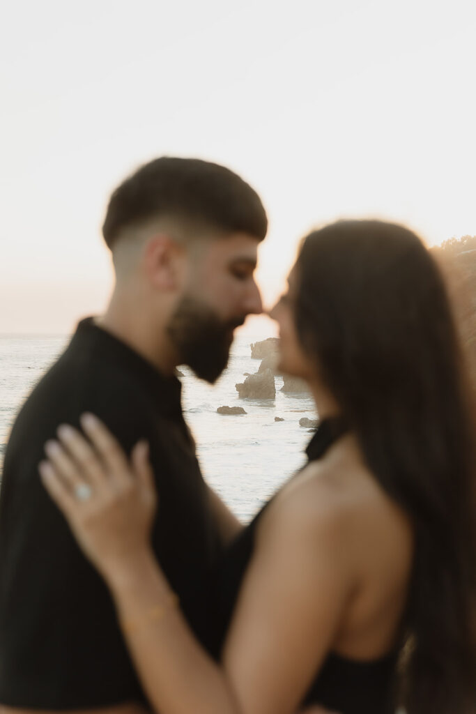 newly engaged couple laughing with each other