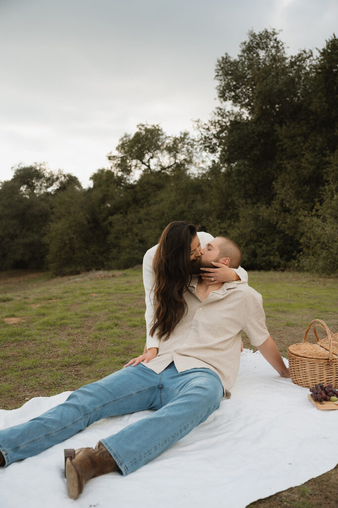 Cute picture of the newly engaged, couple kissing